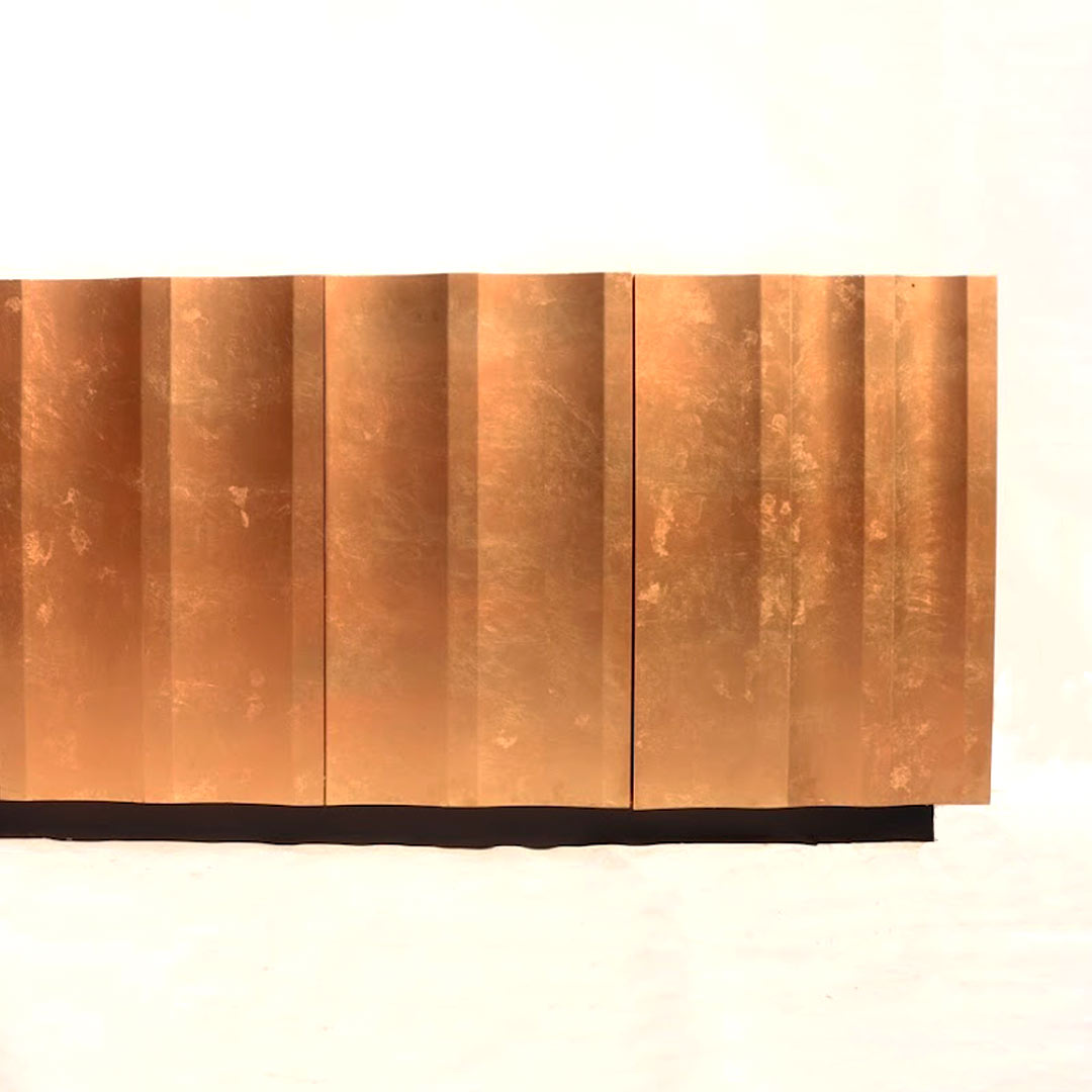 A sideboard showcasing gold, lead, and copper tones, exuding opulence and warmth. The metallic finishes add a touch of glamour and sophistication to the sideboard's design, creating a luxurious statement piece for any dining or living space