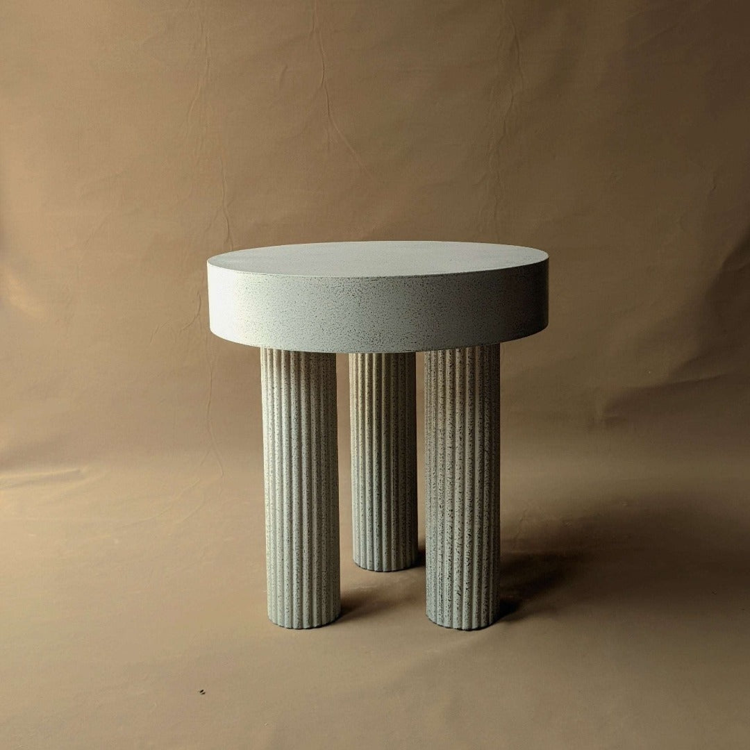 Rustic round side table with a chunky design and textured surface, adding a touch of natural charm to any room.
