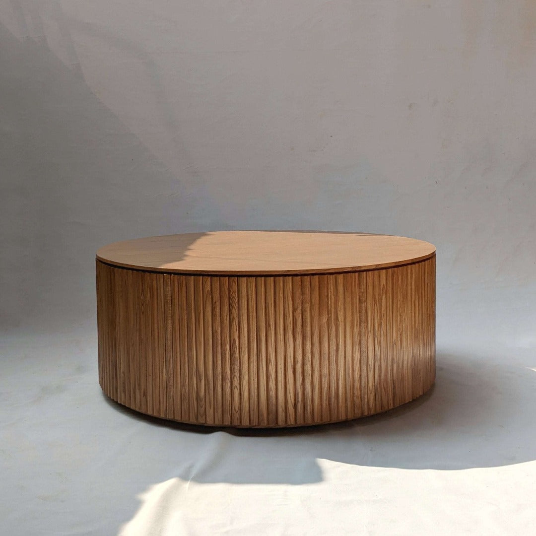 "Chic circular coffee table featuring fluted design, adding texture and sophistication to your living space.