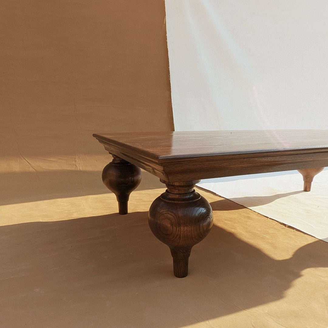 Elevate your space with the Turnip Table featuring solid wood legs and your choice of a solid or veneer top. A perfect blend of style and durability for any setting.