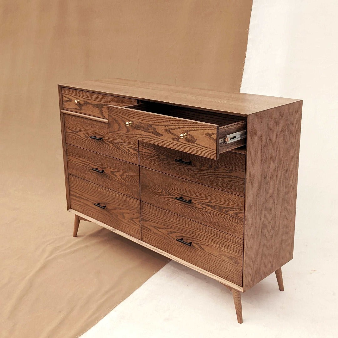 The perfect blend of style and practical storage, this dresser features a classic mid-century modern design that helps organize your space while adding timeless elegance.