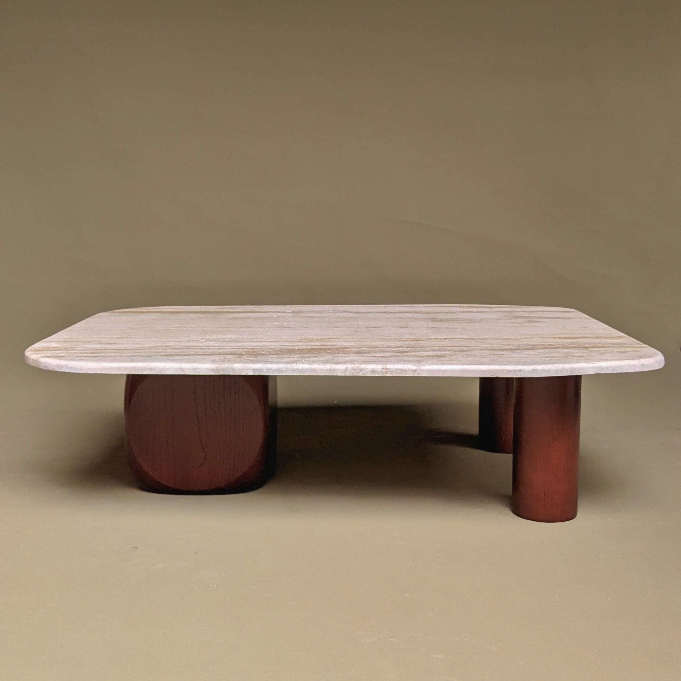 A striking combination travertine and wood table, featuring a smooth travertine tabletop paired with wooden legs or accents. The contrast between the warm, natural wood and the cool, textured travertine creates a harmonious blend of organic elements, adding a touch of rustic sophistication to any space.