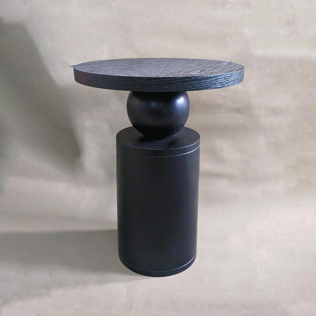 A round sculptural side table, featuring a striking and artistic design. Its sculptural silhouette adds a touch of elegance and visual intrigue to any room, making it a captivating accent piece for modern interior spaces.