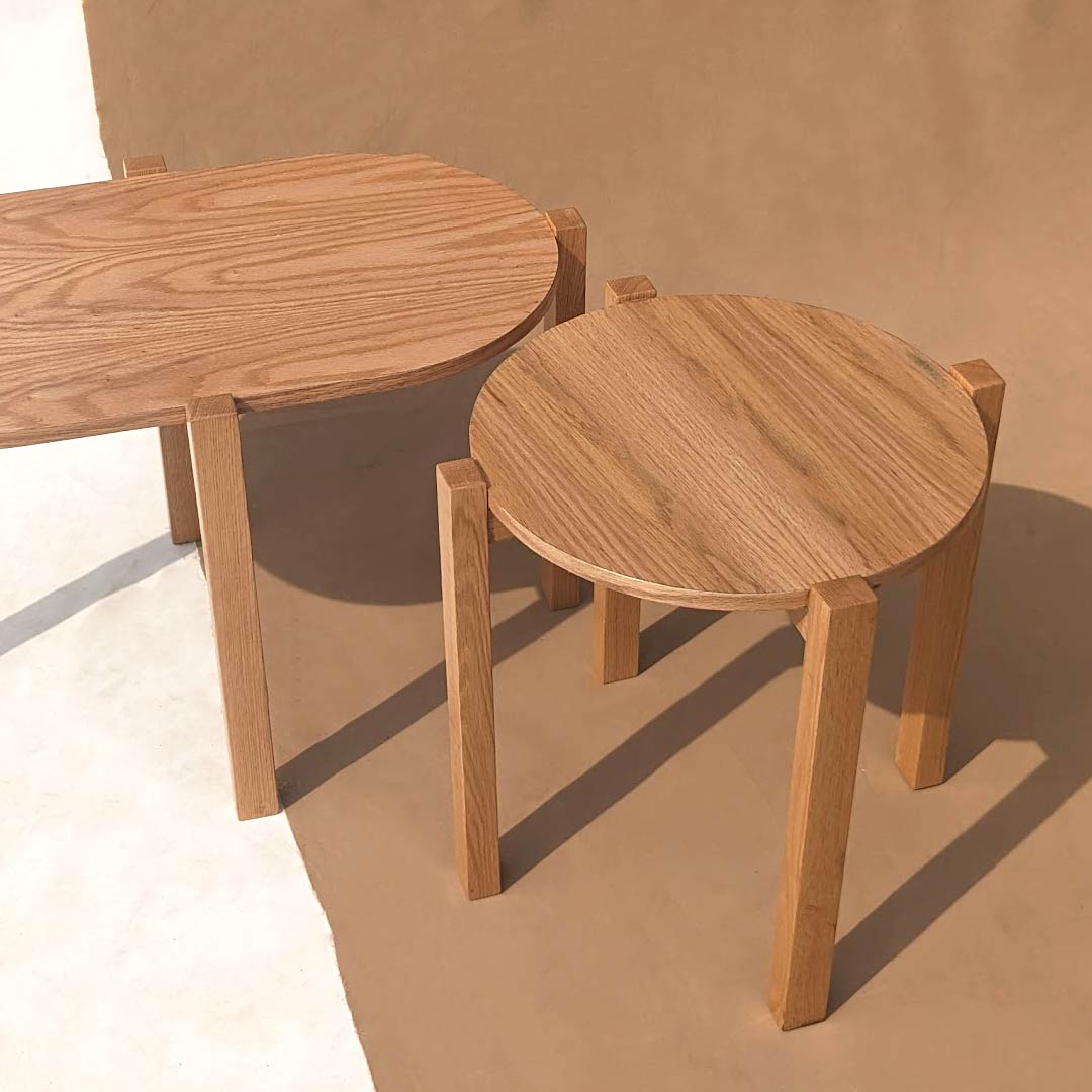 A simple round and oblong stand, offering versatile functionality with its minimalist design. These stands provide a clean and understated platform for displaying decorative items or serving as practical surfaces for everyday use in any room.