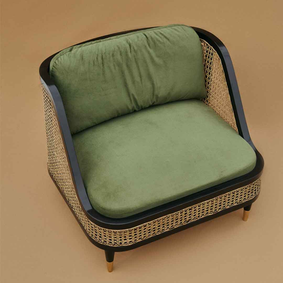 A chair with a cane-woven backrest, adding a rustic yet elegant touch to any space. The woven cane detailing provides a natural and airy feel, enhancing the chair's visual appeal and comfort.