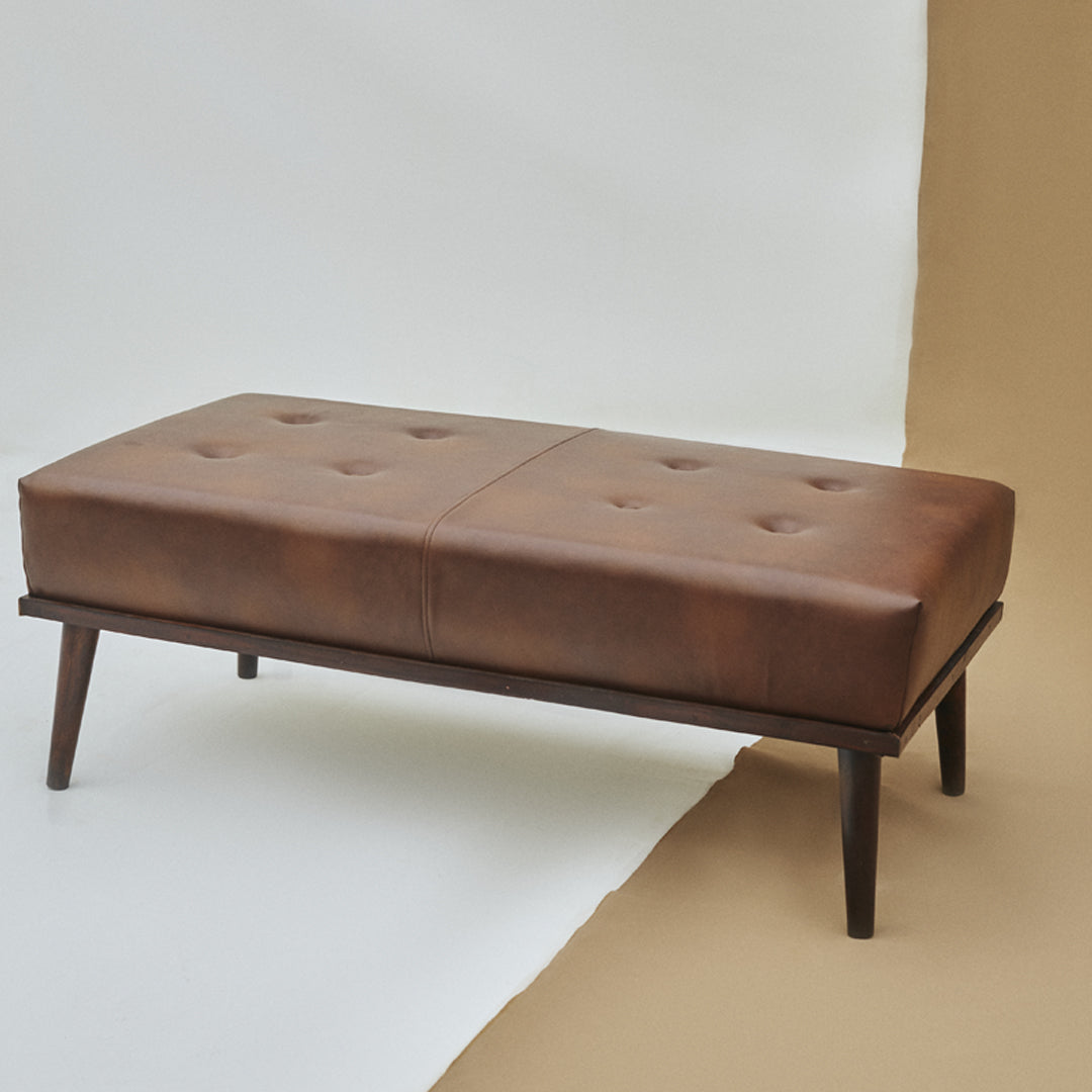 Indulge in luxury with our Ottoman, crafted from high-quality Leatherite and Solid Indian Rosewood. Elevate your space with its exquisite blend of sophistication and durability.