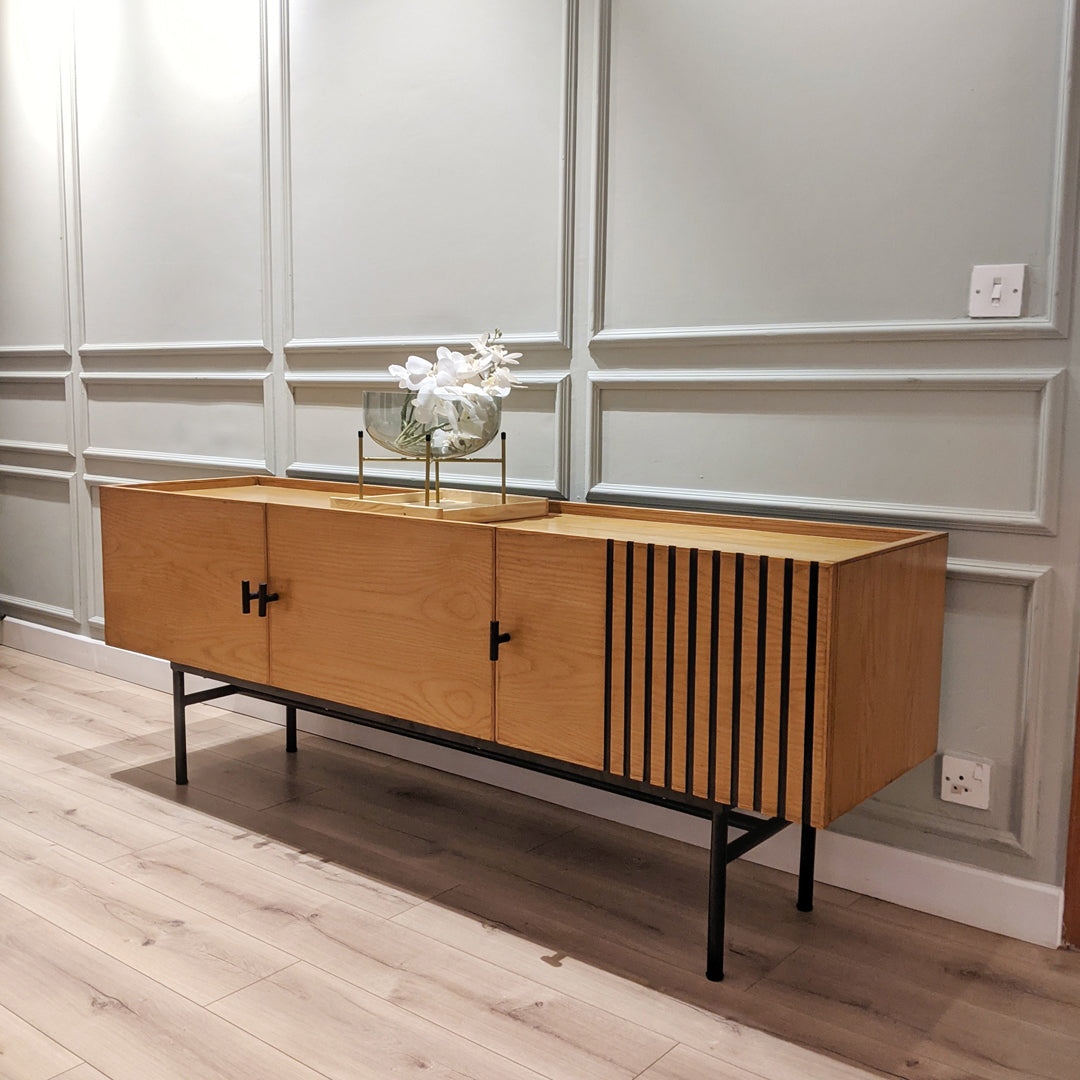 Introducing our functional yet stylish Sideboard, crafted from Ash Veneer and solid Ash wood with sleek metal legs. Perfect for compact spaces, it offers ample storage while adding a touch of modern elegance to your home.
