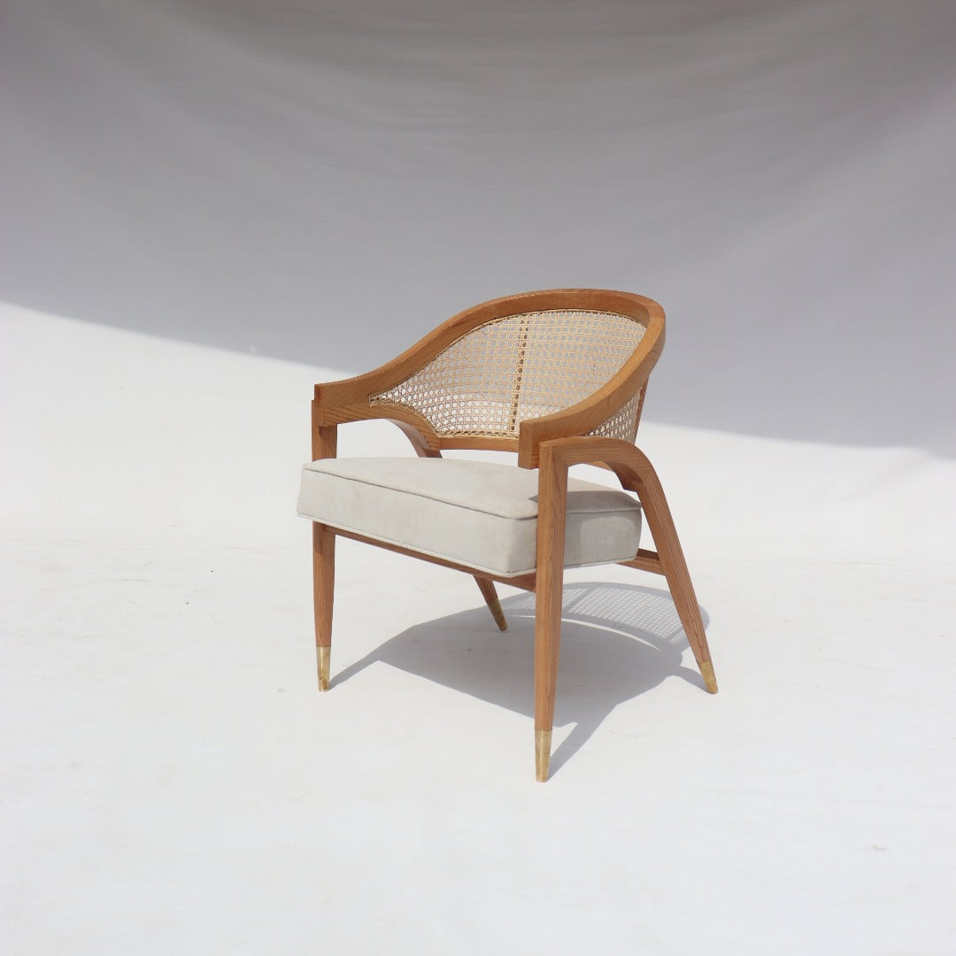 Crafted with precision and artistry, the Edward Wormley Chair blends solid red oak, brass fittings, and hand-woven rattan for a timeless and elegant design.