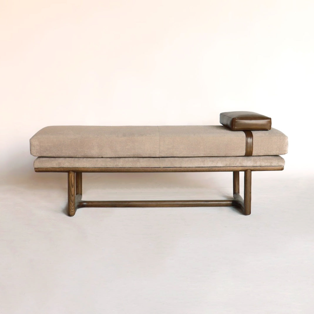 A stylish bench featuring a soft leatherette cushion, providing both comfort and elegance to any space with its detailed design.