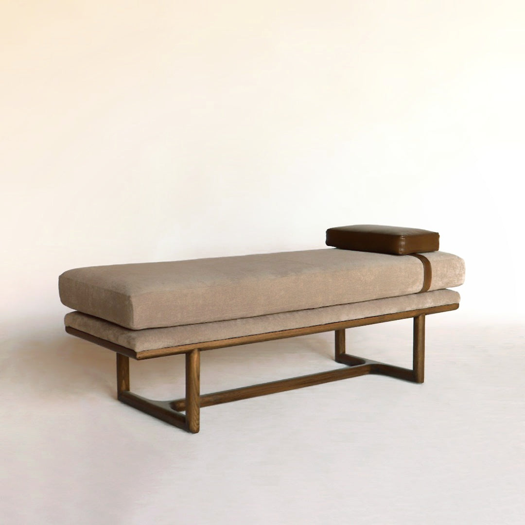 A stylish bench featuring a soft leatherette cushion, providing both comfort and elegance to any space with its detailed design.