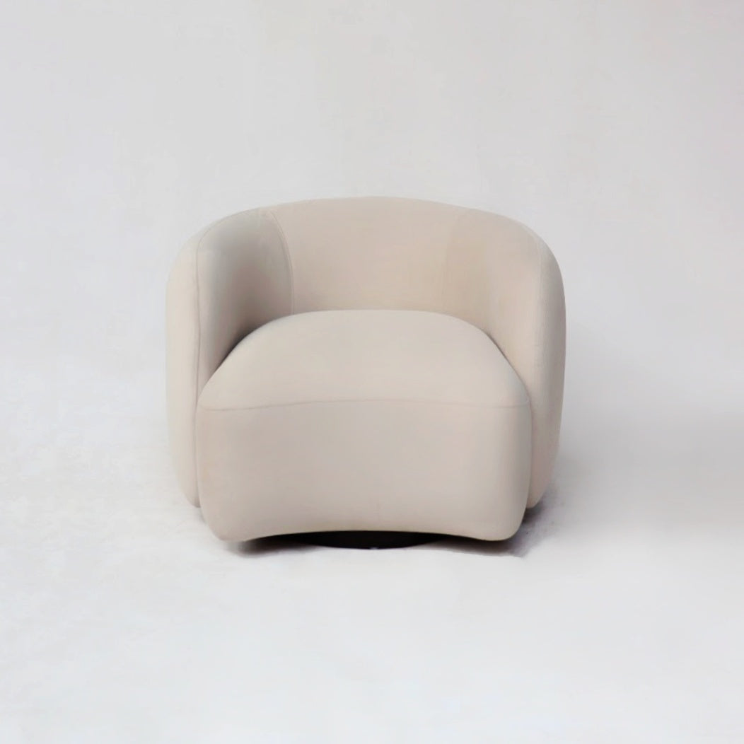 A cozy chair upholstered in soft, comfortable fabric, inviting relaxation and leisure. Its plush cushions and ergonomic design ensure a comfortable seating experience, making it the perfect spot for unwinding after a long day.