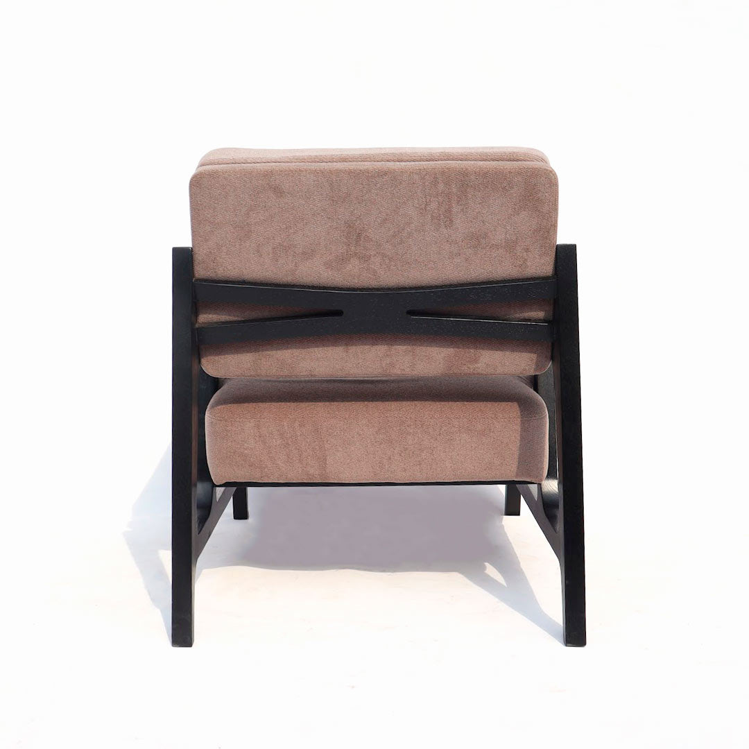 A spacious and inviting chair featuring a sleek design without cushions, providing ample room for relaxation and making a bold statement in any space