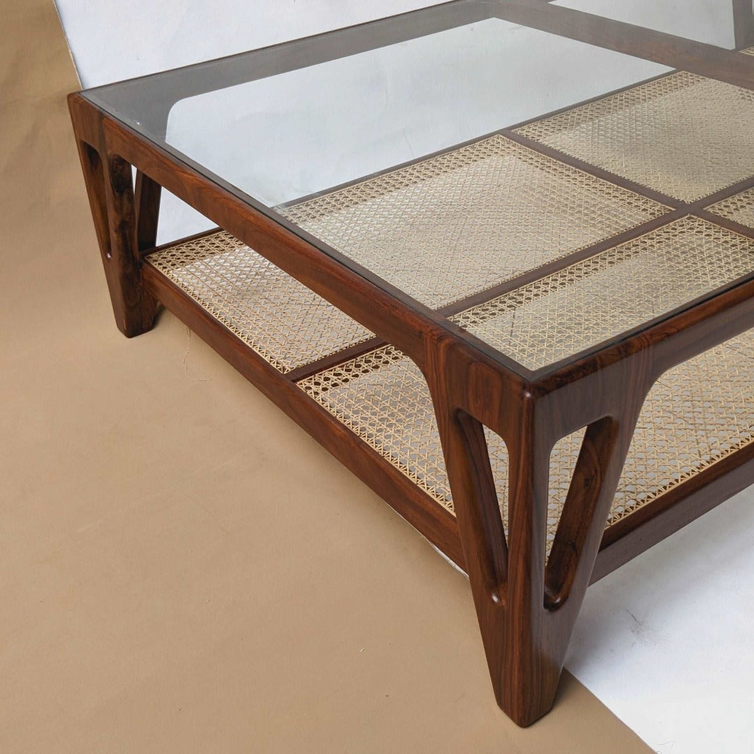 A coffee table with a cane-woven top, infusing natural charm and texture into the living space. The intricate cane pattern adds visual interest and depth, while the sturdy construction ensures both style and functionality.