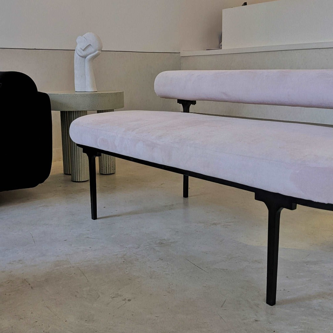 A chic bench with a low backrest, epitomizing modern elegance and sophistication. Its sleek design and minimalist silhouette make it a stylish addition to any space, offering both comfort and visual appeal