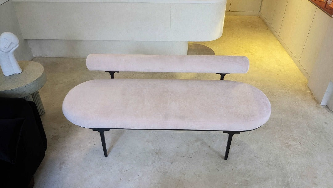 A chic bench with a low backrest, epitomizing modern elegance and sophistication. Its sleek design and minimalist silhouette make it a stylish addition to any space, offering both comfort and visual appeal