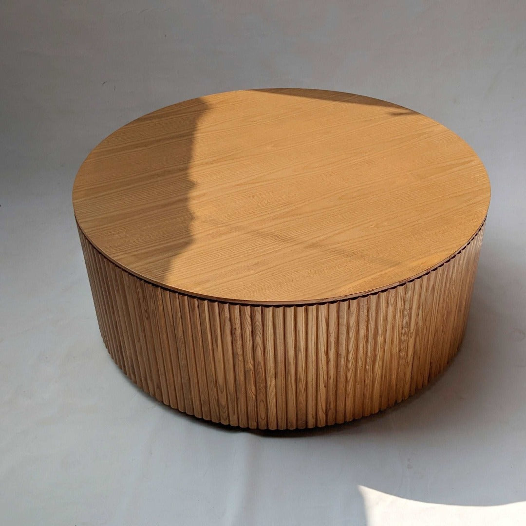 "Chic circular coffee table featuring fluted design, adding texture and sophistication to your living space.
