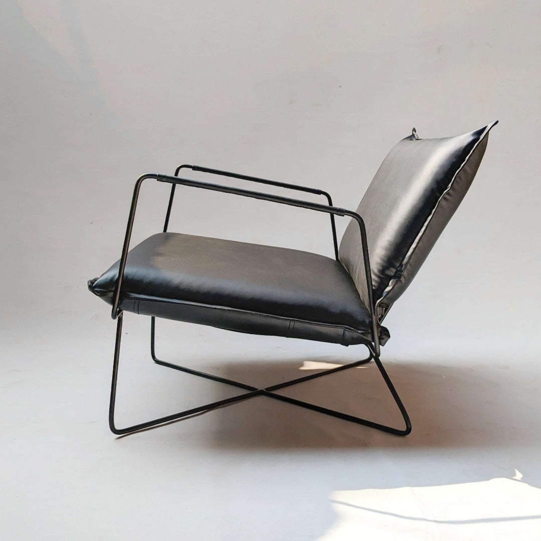  A sleek chair crafted with leatherette upholstery and metal frame, epitomizing modern elegance. The smooth leatherette and polished metal seamlessly blend contemporary style with durability, making it a chic addition to any space.