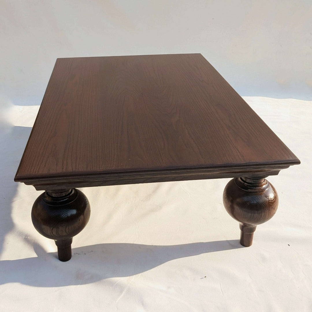 Elevate your space with the Turnip Table featuring solid wood legs and your choice of a solid or veneer top. A perfect blend of style and durability for any setting.