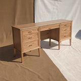 Sophisticated dressing table featuring seven drawers, crafted from Solid Red Oak and Red Oak veneer, adorned with brass handles for a touch of luxury.