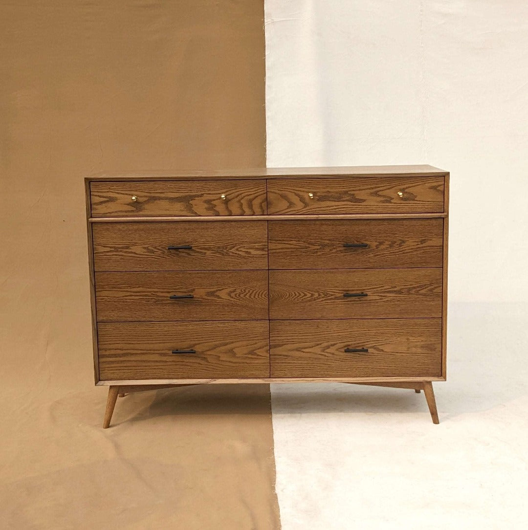 The perfect blend of style and practical storage, this dresser features a classic mid-century modern design that helps organize your space while adding timeless elegance.
