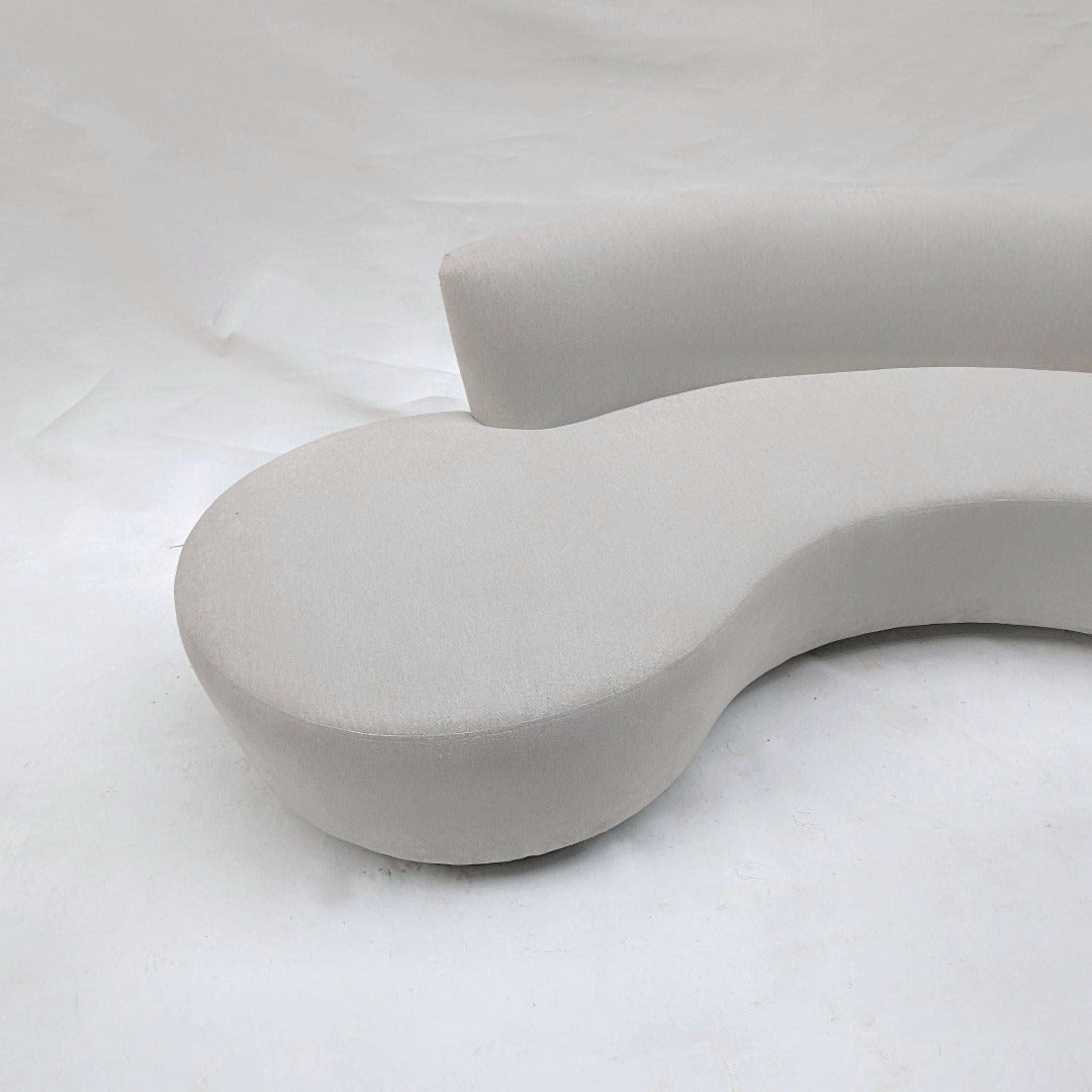 A curved contour couch, designed with sleek lines and ergonomic curves to provide both style and comfort. Its contoured shape follows the natural curves of the body, offering support and relaxation, while adding a modern touch to any living room.