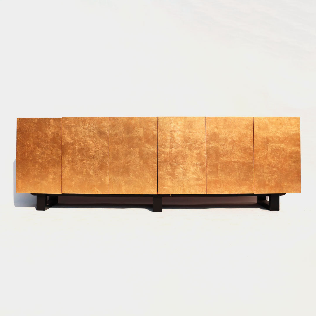 A console featuring elegant gold detailing and ample storage space, combining luxury with functionality. The gold accents add a touch of sophistication to the console's design, while the storage compartments offer practicality and organization for any entryway or living room.
