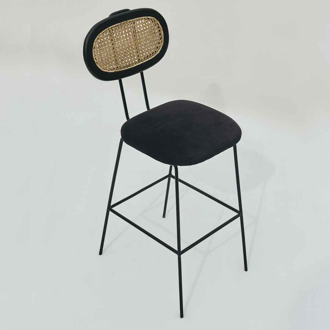 Bar stool featuring a perfect blend of steel, wood, and cane for a harmonious combination of modern and natural elements.
