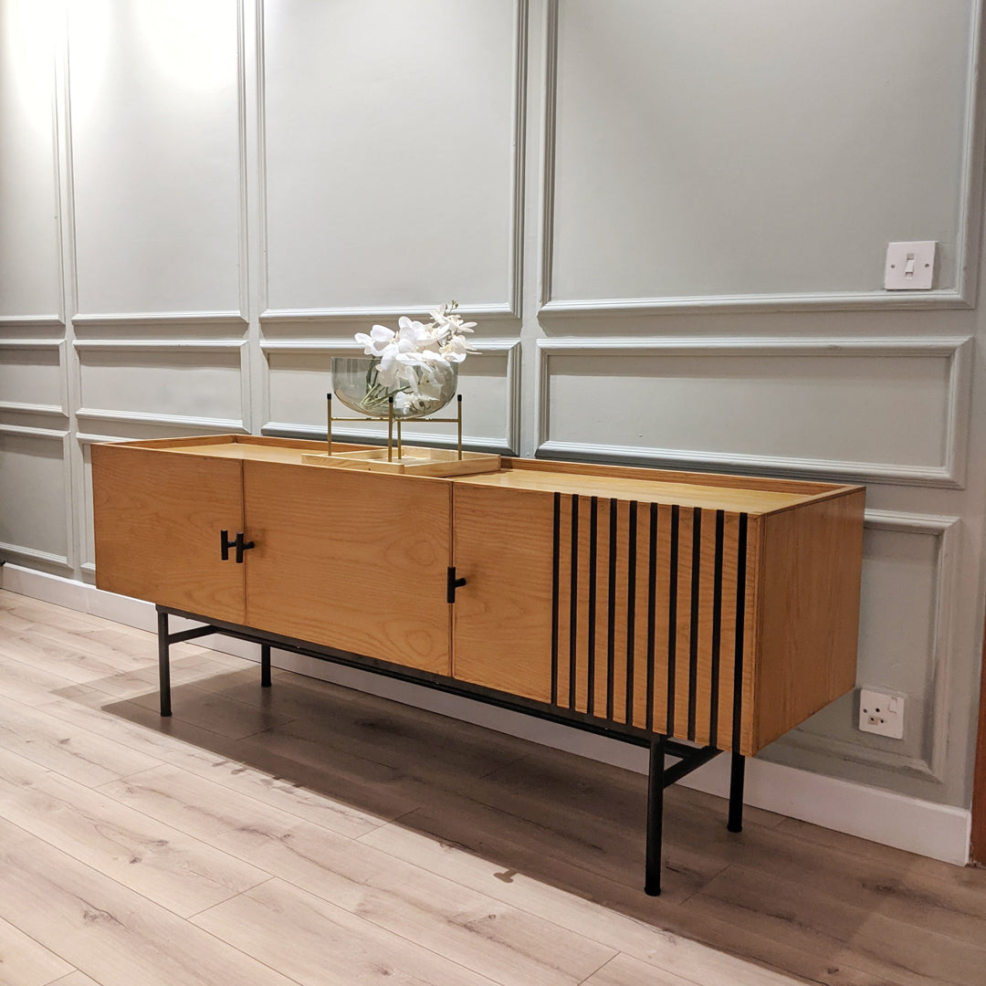Introducing our functional yet stylish Sideboard, crafted from Ash Veneer and solid Ash wood with sleek metal legs. Perfect for compact spaces, it offers ample storage while adding a touch of modern elegance to your home.
